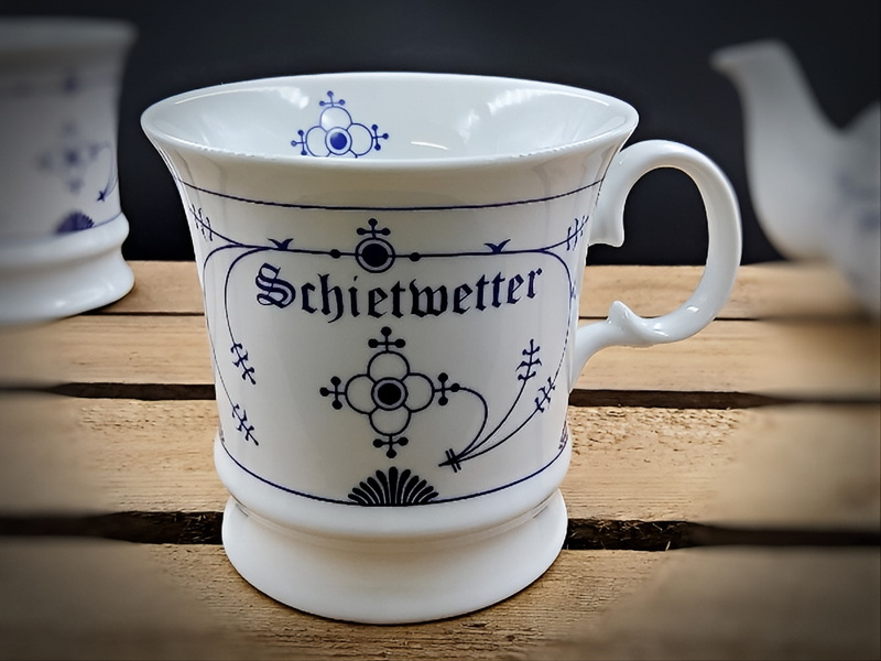 Elegante Porzellantasse mit indisch blauer Schrift und filigranen Verzierungen im zeitlosen Stil